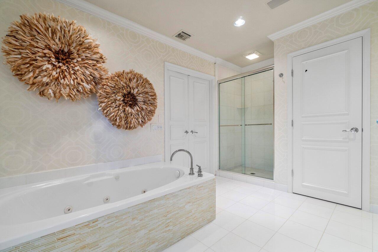 2377 East Silver Palm Road Boca Raton, FL 33432 - Photo 12 of 40 a bathroom with a bathtub and shower