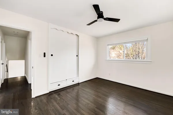 a view of a livingroom with wooden floor and white walls