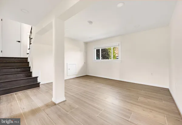 a view of an entryway with wooden floor