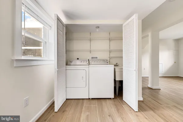 a utility room with cabinets washer and dryer