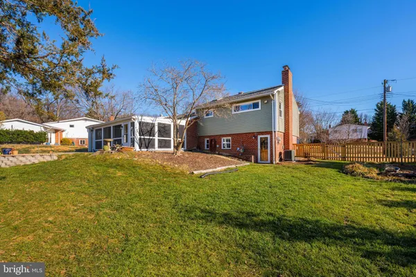 a front view of a house with a garden and sitting area