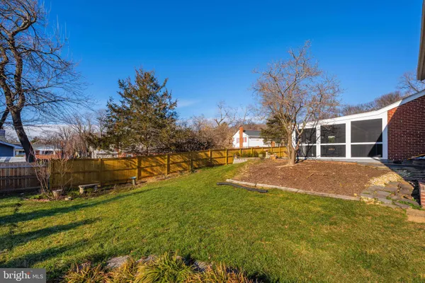 a view of yard with swimming pool and green space