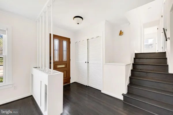 a view of an entryway with wooden floor and staircase