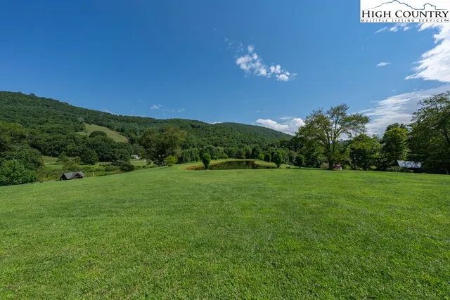 a view of a wooden deck and a yard