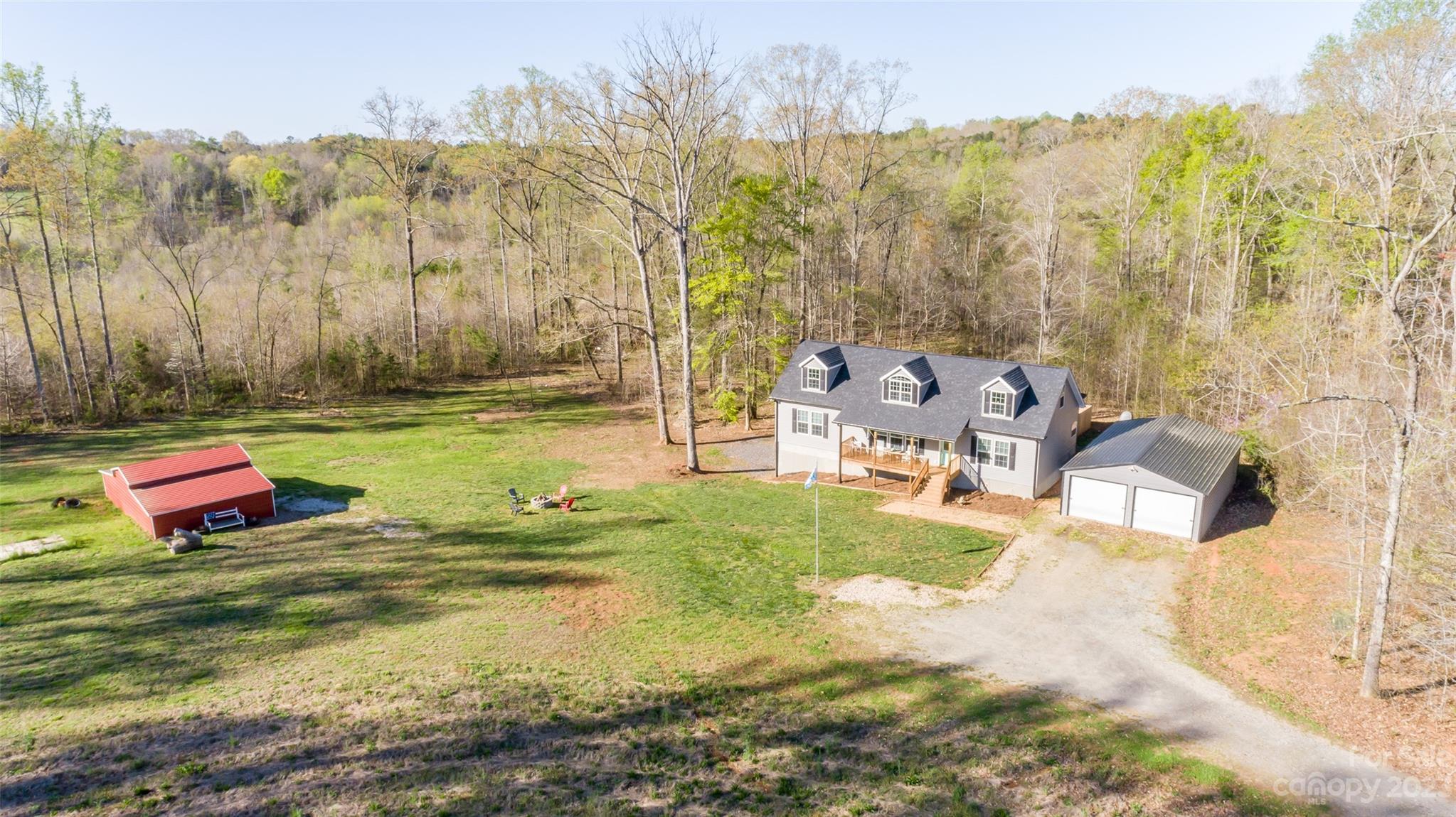 740 Renshaw Ford Road Woodleaf, NC 27054 - Photo 1 of 33 a backyard of a house with table and chairs