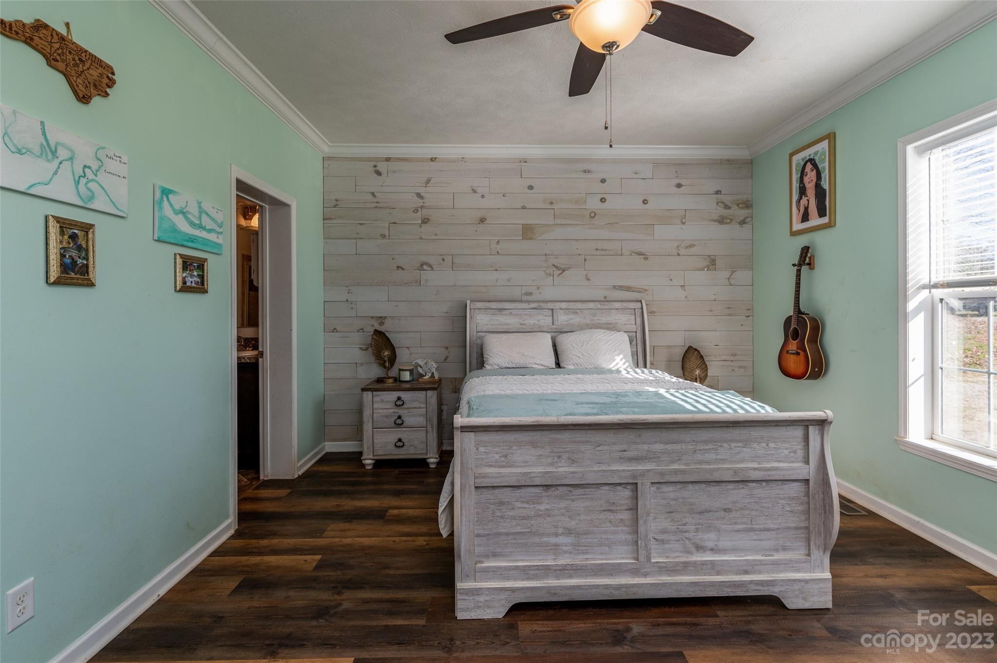 740 Renshaw Ford Road Woodleaf, NC 27054 - Photo 21 of 33 a bedroom with a bed and a chandelier fan