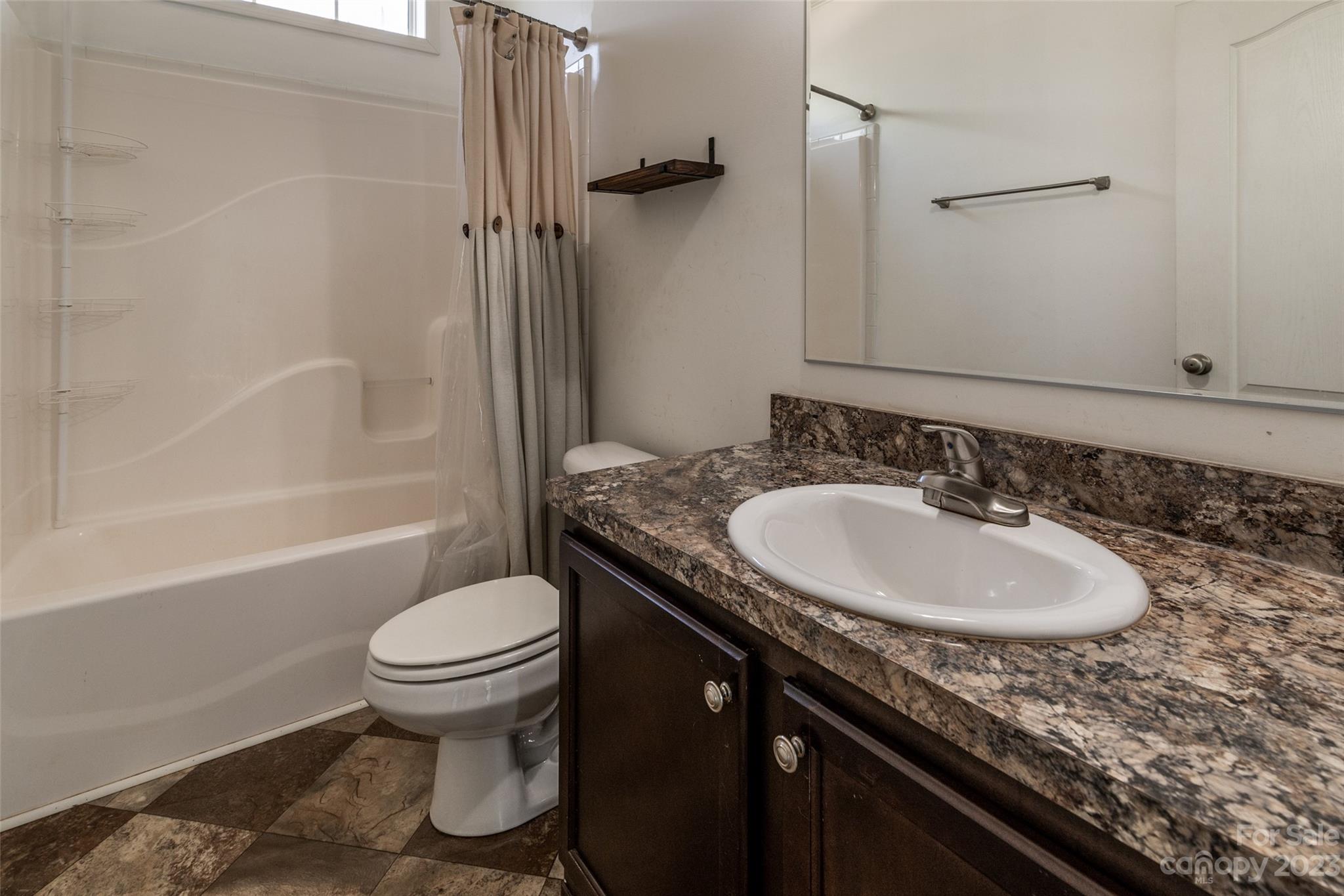 740 Renshaw Ford Road Woodleaf, NC 27054 - Photo 26 of 33 a bathroom with a granite countertop sink toilet and shower