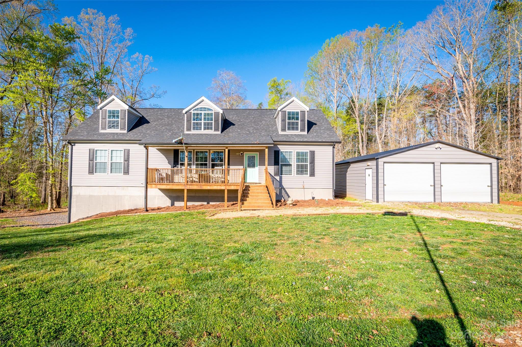 740 Renshaw Ford Road Woodleaf, NC 27054 - Photo 5 of 33 a view of a house with a backyard