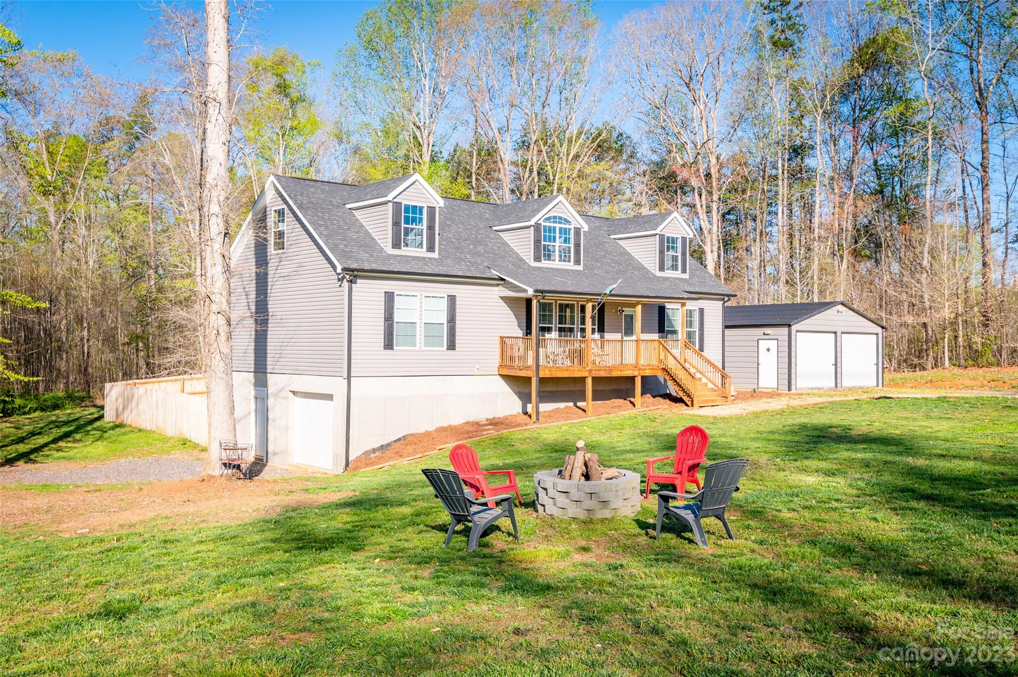 740 Renshaw Ford Road Woodleaf, NC 27054 - Photo 6 of 33 a backyard of a house with table and chairs