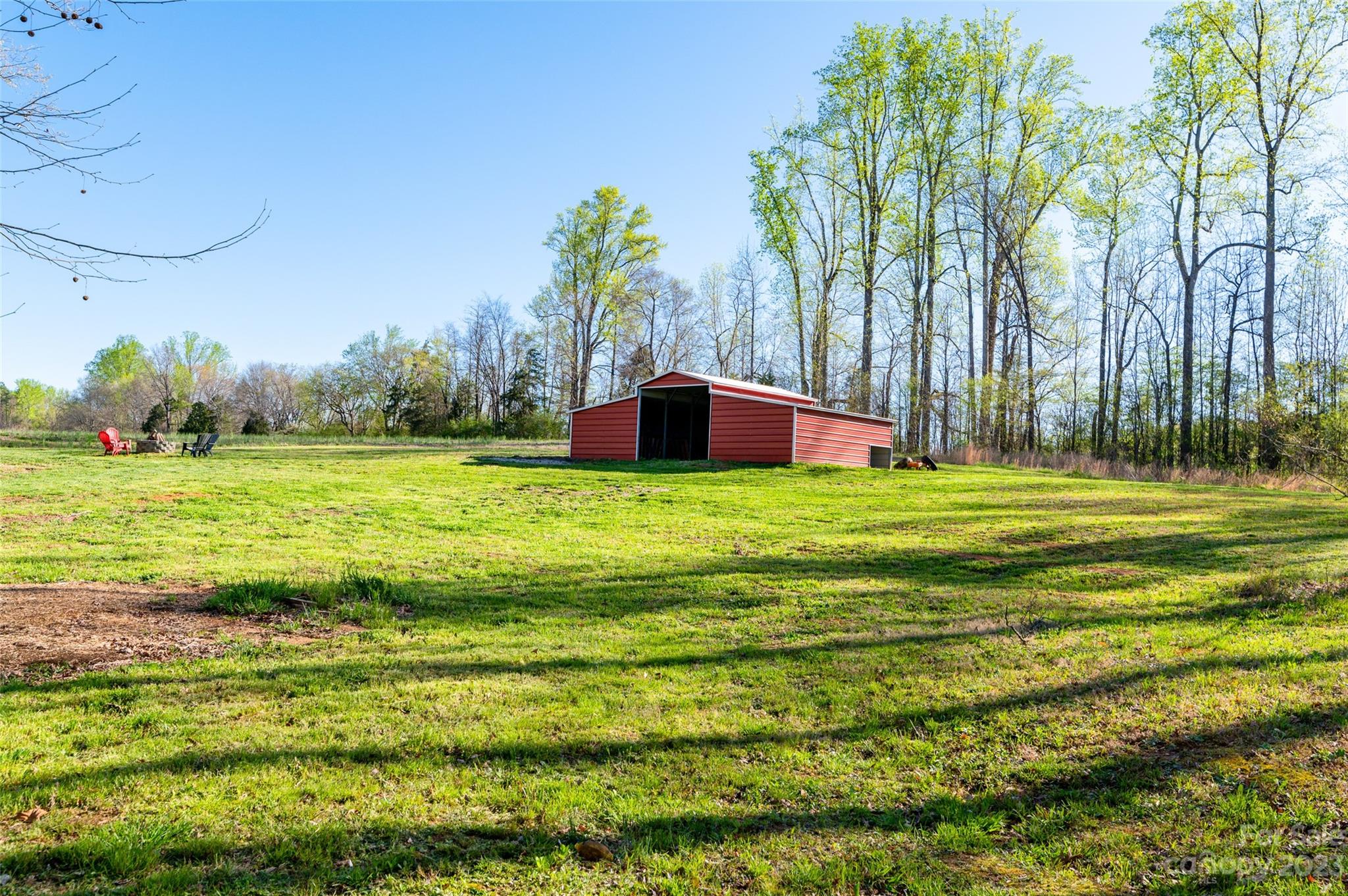 740 Renshaw Ford Road Woodleaf, NC 27054 - Photo 10 of 33 a view of a field with trees in front of it