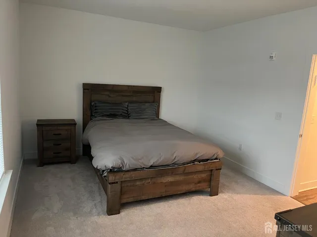 a bed sitting in a bedroom next to a window