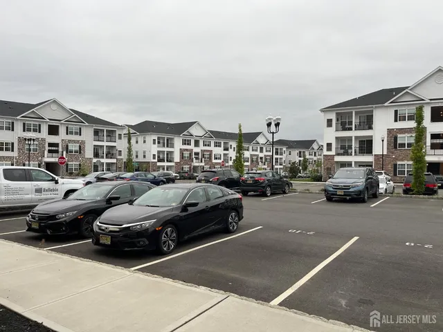 a city street with cars parked in front of it