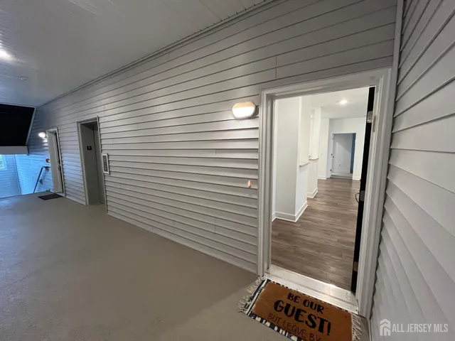 a view of a hallway to rooms