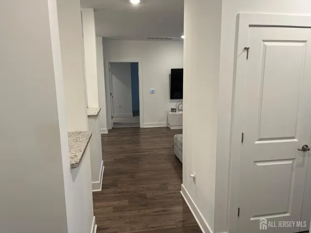 a view of hallway with wooden floor