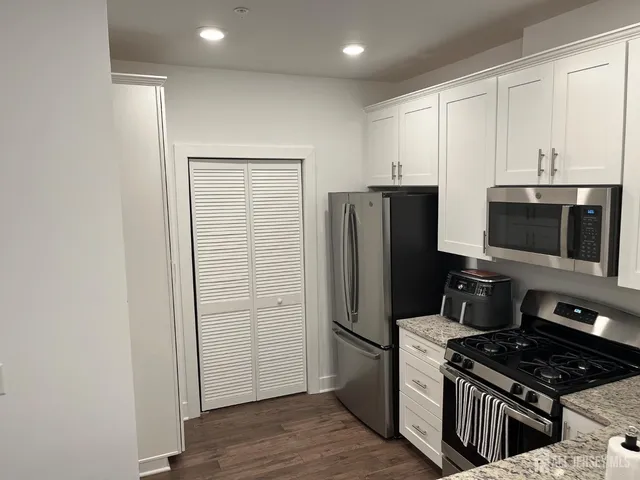 a kitchen with a refrigerator stove and microwave
