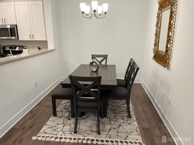 a view of a workspace with furniture and wooden floor