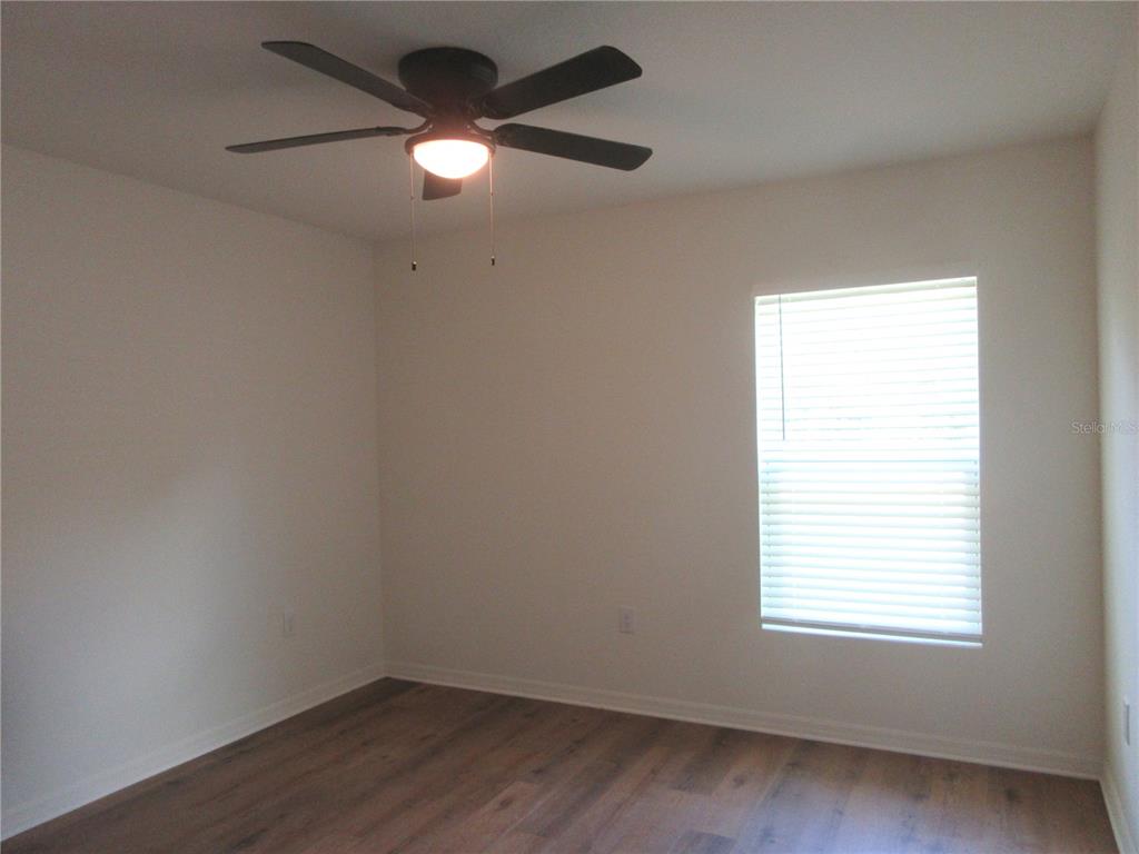 13130 Southwest 78th Circle Ocala, FL 34473 - Photo 11 of 14 an empty room with a window and a fan