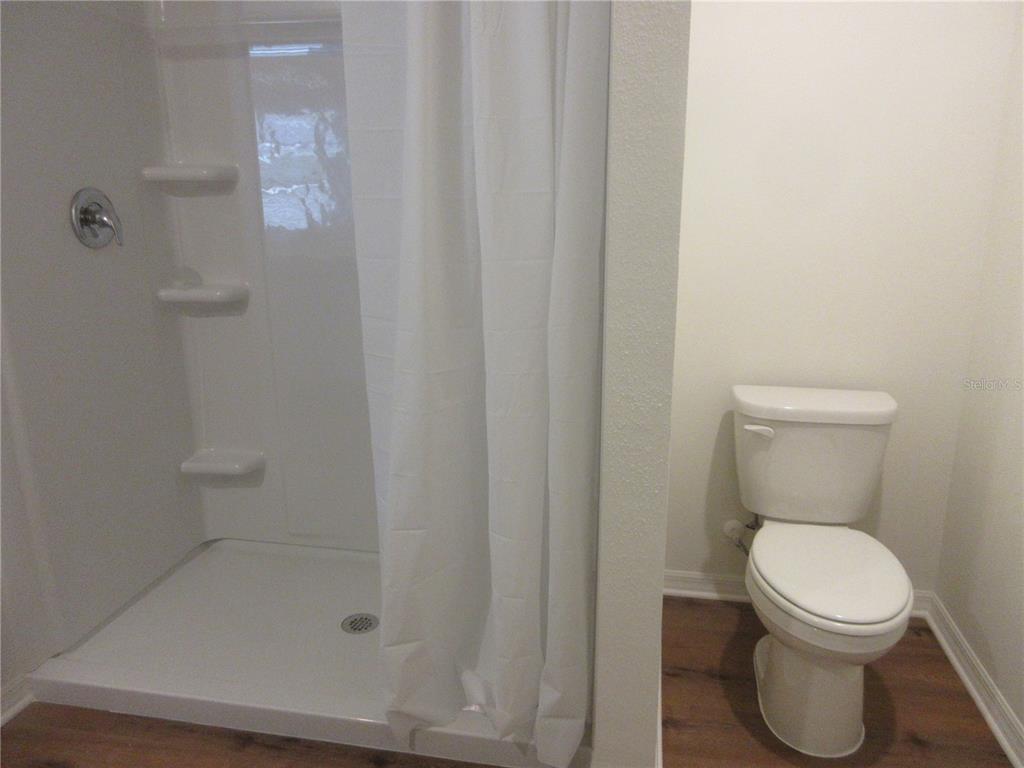 13130 Southwest 78th Circle Ocala, FL 34473 - Photo 7 of 14 a bathroom with a toilet and shower