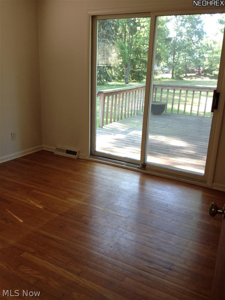 37700 Bainbridge Road Solon, OH 44139 - Photo 8 of 13 Bedroom 3 or TV Room with hardwood floor, sliders lead to Deck.