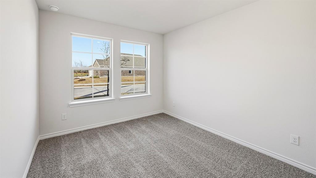 403 Flintlock Road Caddo Mills, TX 75135 - Photo 7 of 26 Carpeted spare room featuring baseboards