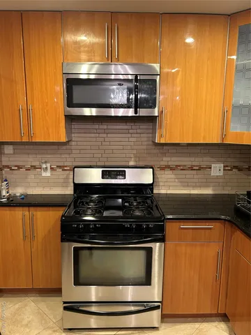 a stove top oven sitting inside of a kitchen