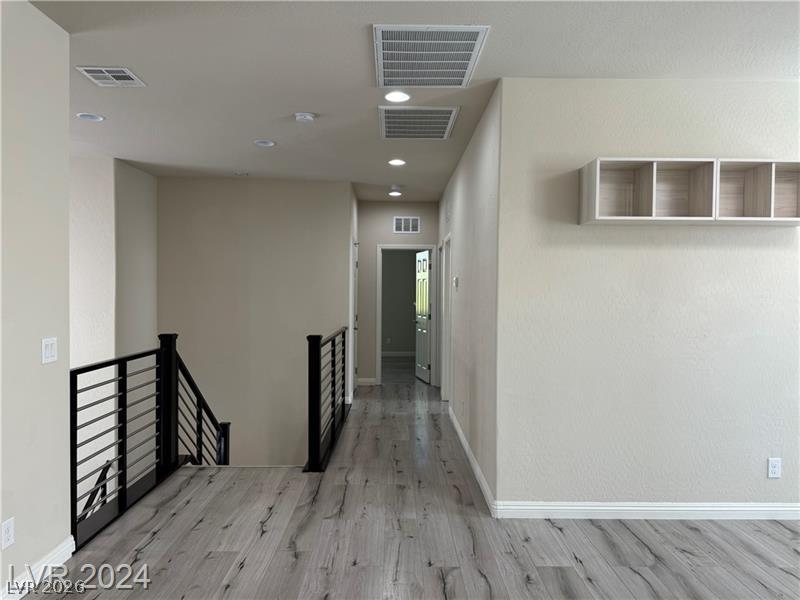 9056 Tony Ridge Avenue Las Vegas, NV 89148 - Photo 10 of 32 An inviting interior landing showcases modern railings and durable flooring, connecting living spaces seamlessly.