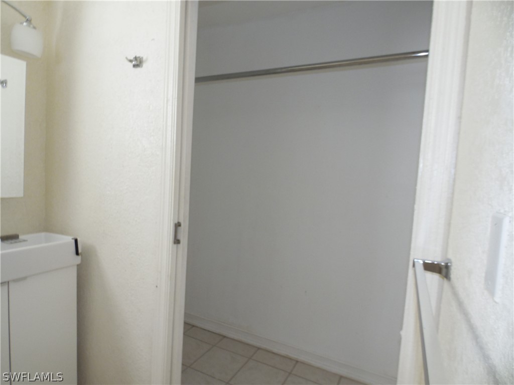 102 Alabama Road South Lehigh Acres, FL 33936 - Photo 14 of 24 a bathroom with a glass shower door