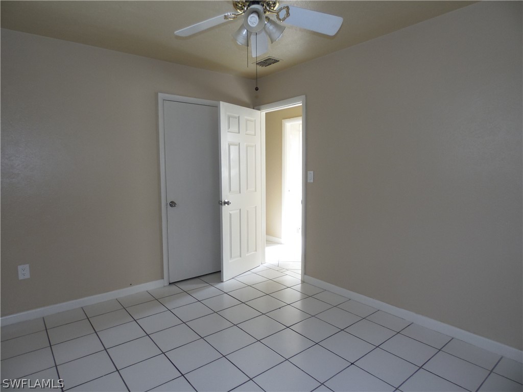 102 Alabama Road South Lehigh Acres, FL 33936 - Photo 15 of 24 a view of an empty room and chandelier fan