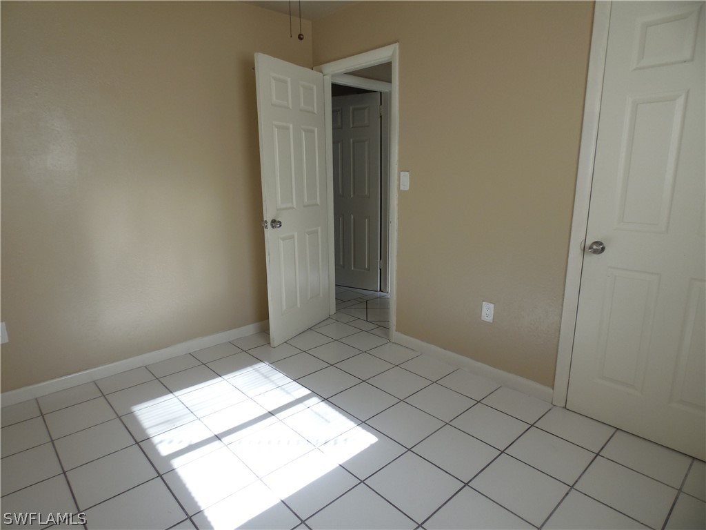 102 Alabama Road South Lehigh Acres, FL 33936 - Photo 18 of 24 a view of an empty room and window