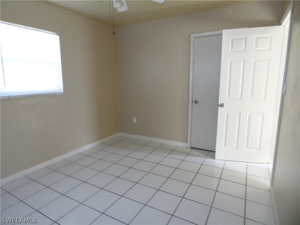102 Alabama Road South Lehigh Acres, FL 33936 - Photo 20 of 24 a view of an empty room and window