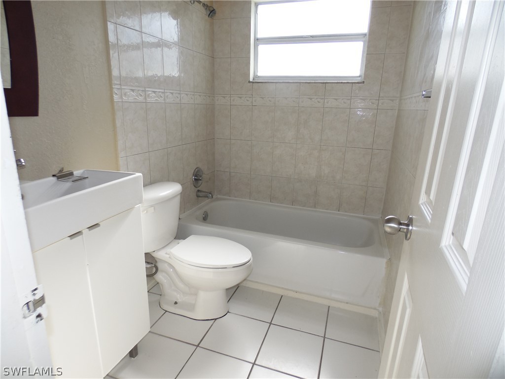 102 Alabama Road South Lehigh Acres, FL 33936 - Photo 21 of 24 a bathroom with a toilet sink and shower
