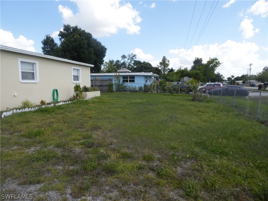 102 Alabama Road South Lehigh Acres, FL 33936 - Photo 23 of 24 a view of a backyard with plants and a garden