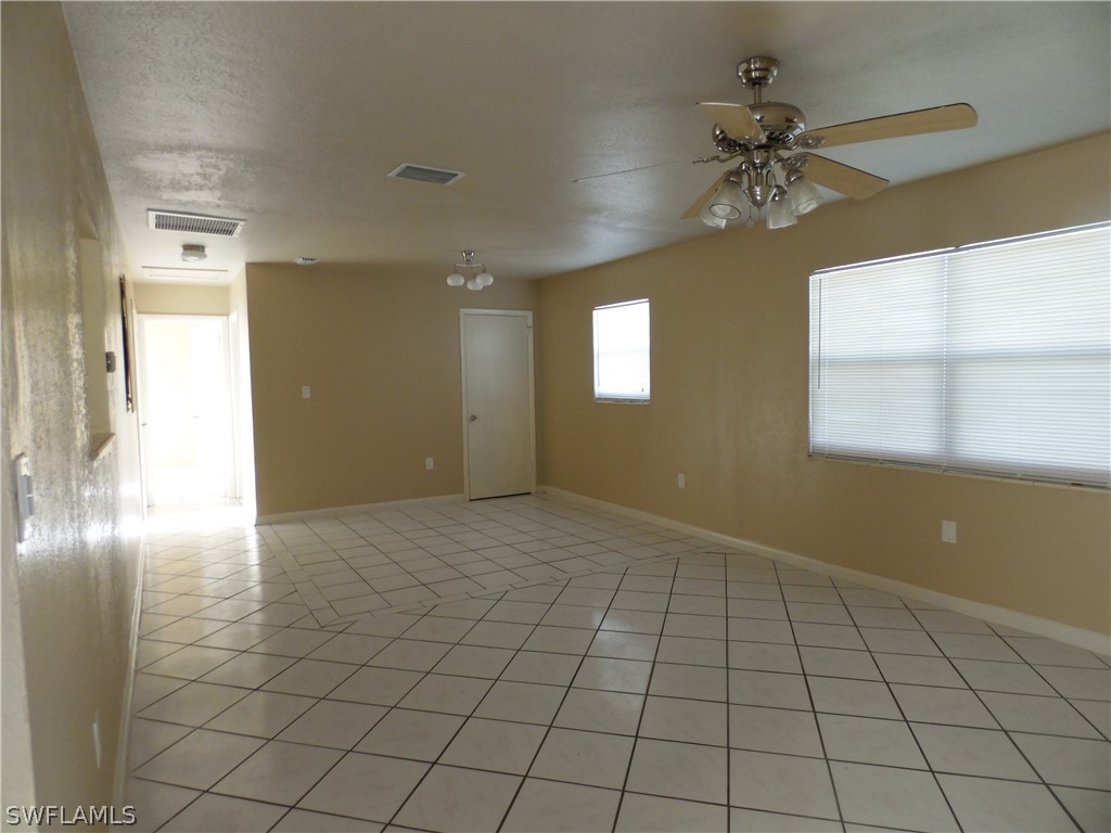 102 Alabama Road South Lehigh Acres, FL 33936 - Photo 4 of 24 a view of an empty room and window