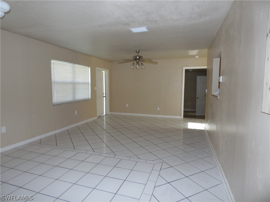 102 Alabama Road South Lehigh Acres, FL 33936 - Photo 6 of 24 an empty room with fan and windows