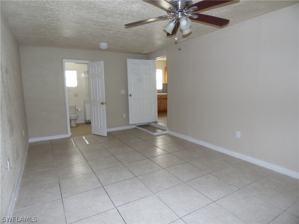 102 Alabama Road South Lehigh Acres, FL 33936 - Photo 10 of 24 an empty room with fan and windows