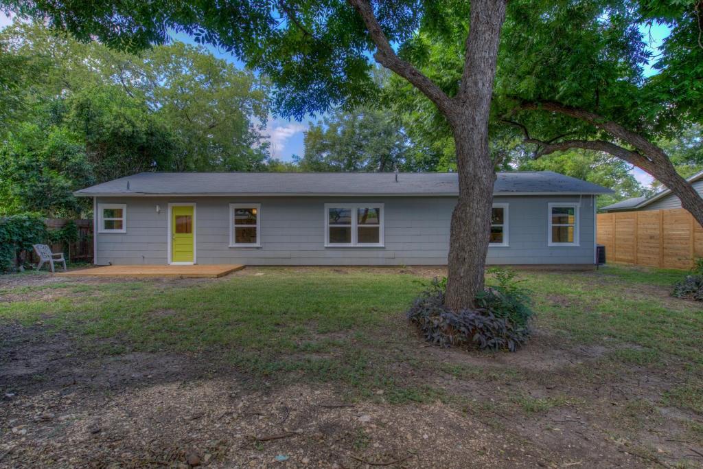 2011 Fort View Road Austin, TX 78704 - Photo 26 of 28 Mature trees shade a spacious backyard bordered by a wooden privacy fence.