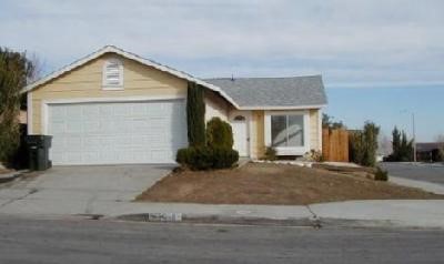 13696 Ridgeline Road Victorville, CA 92392 - Photo 1 of 1 a front view of a house with a yard and garage