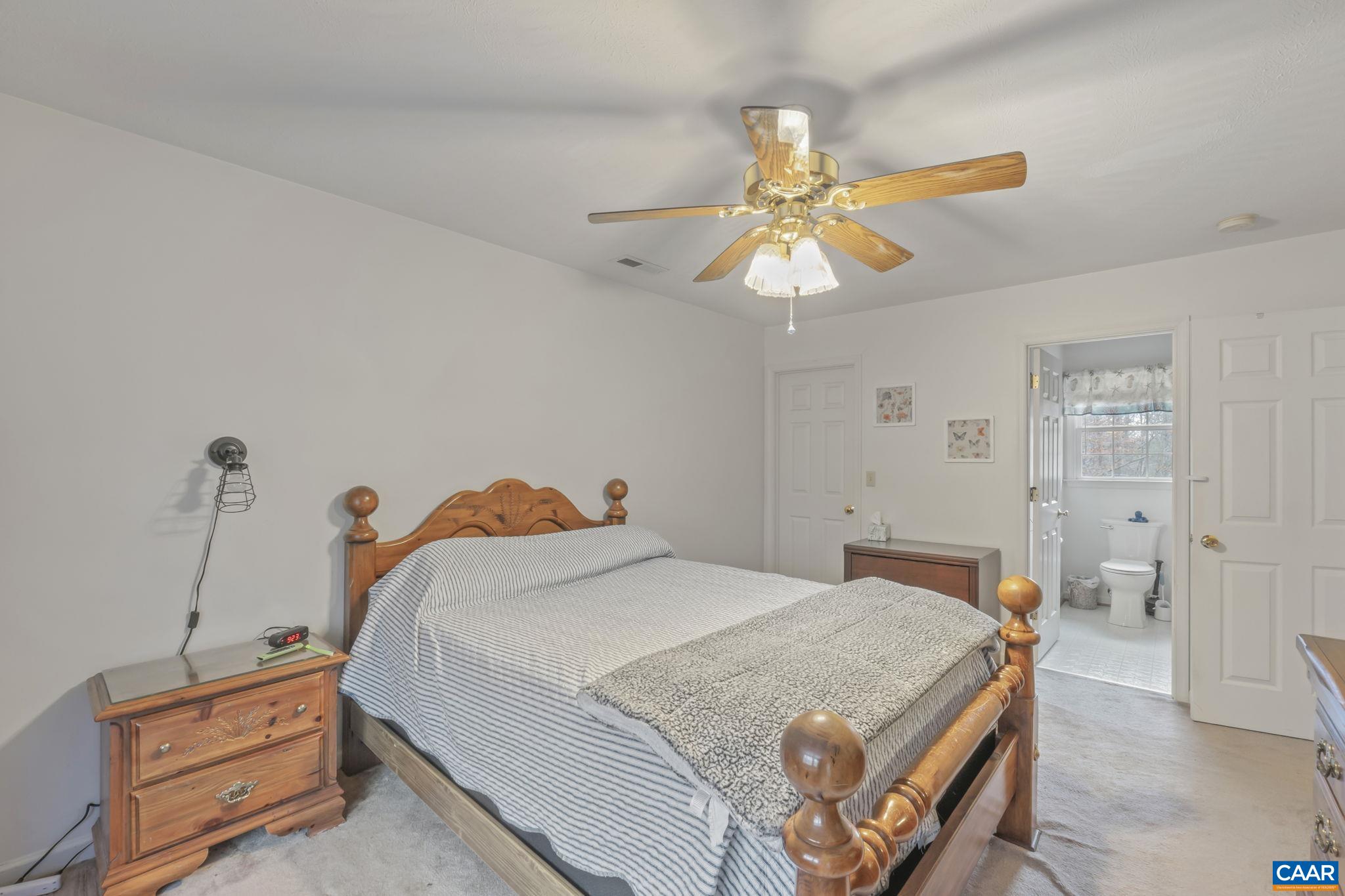 4 Rudolph Street Ruckersville, VA 22968 - Photo 23 of 36 a bedroom with a bed and a chandelier