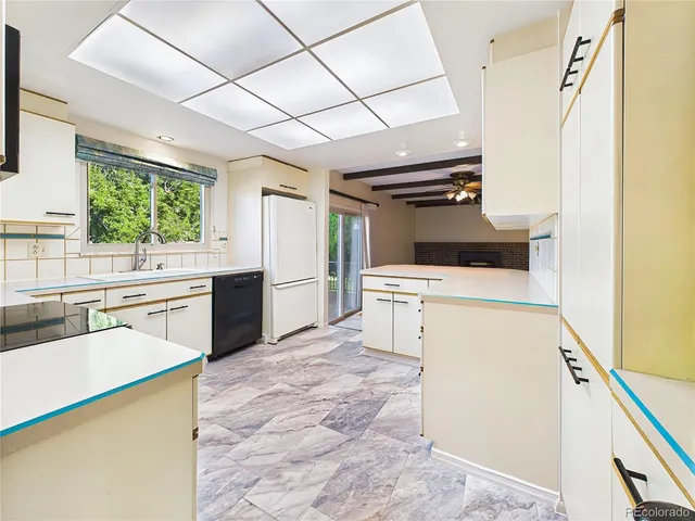 a kitchen with a sink stove and microwave