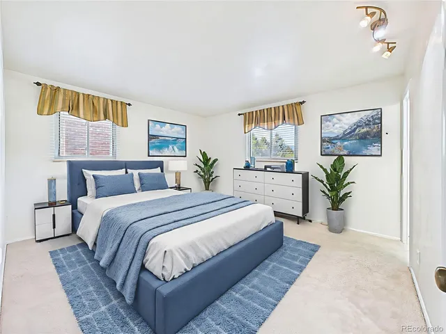 a spacious bedroom with a bed a mirror and a walk in closet