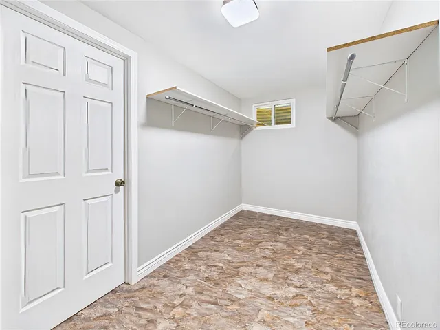 a bathroom with a granite countertop sink a toilet and a shower