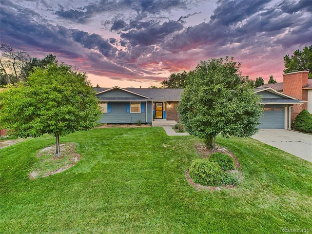 a view of a house with backyard sitting area and garden