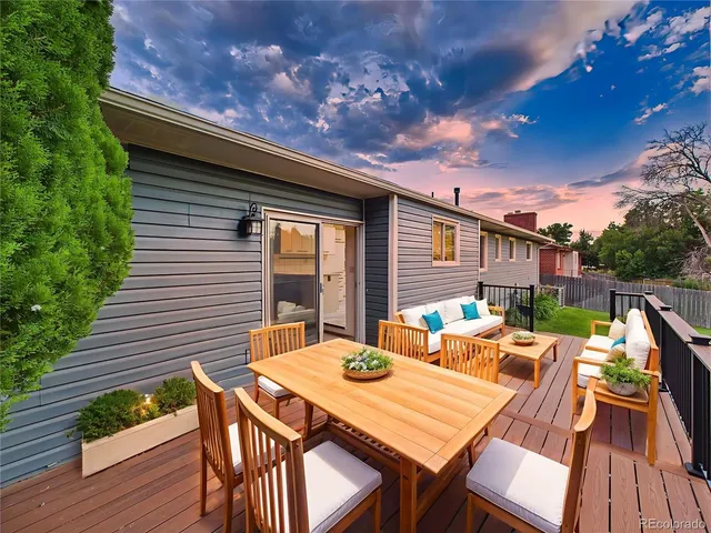 a view of a swimming pool with deck and a garden