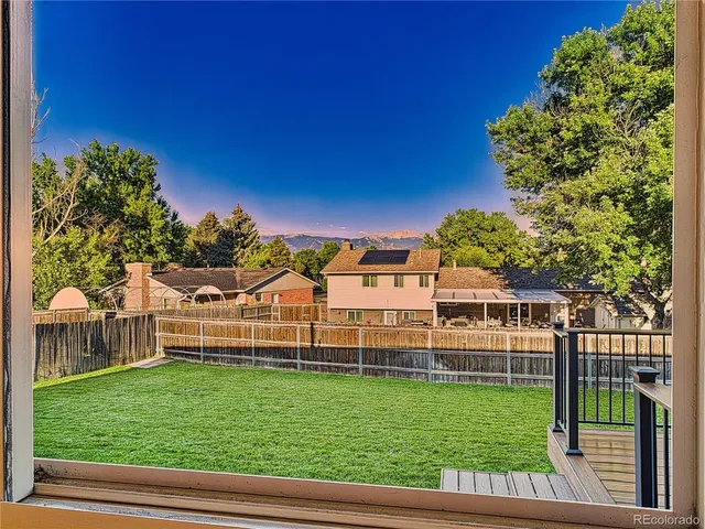 a view of a dining room with furniture wooden floor and chandelier