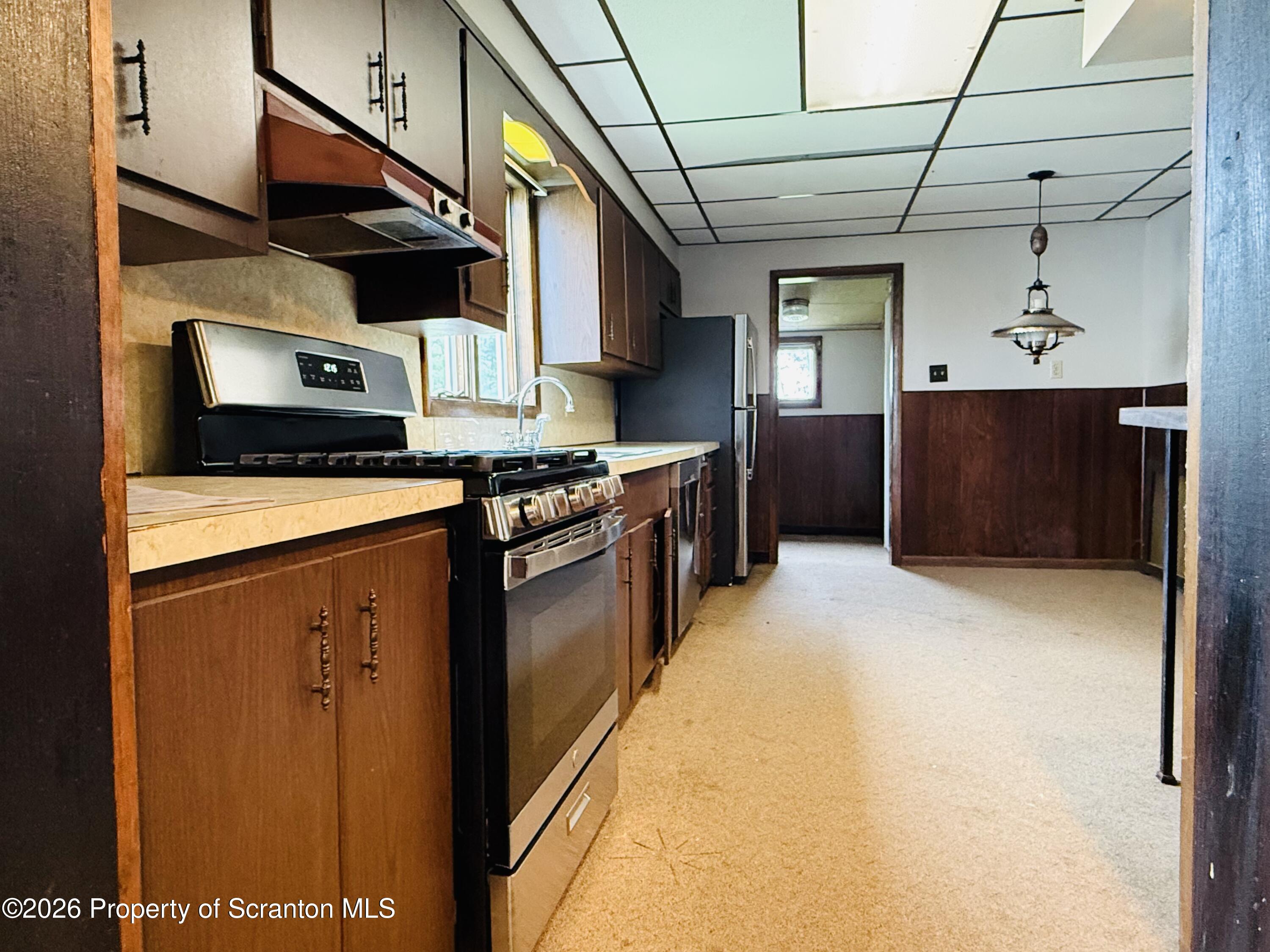 1922 Lafayette Street Scranton, PA 18504 - Photo 7 of 17 a kitchen with stainless steel appliances granite countertop a stove a sink and a refrigerator