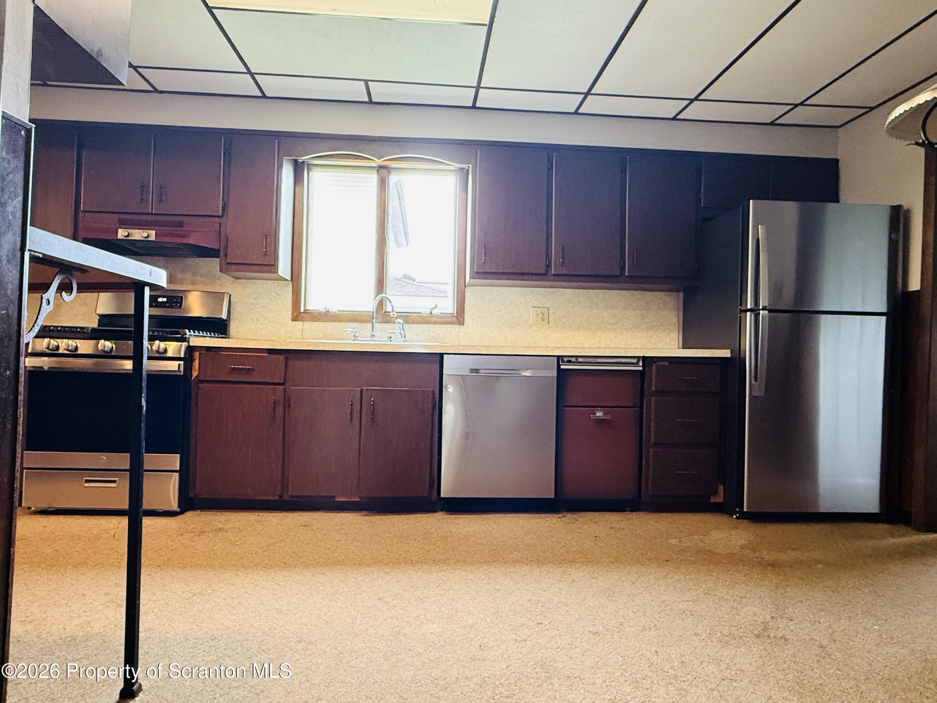 1922 Lafayette Street Scranton, PA 18504 - Photo 8 of 17 a kitchen with stainless steel appliances granite countertop a refrigerator a sink dishwasher with a stove top oven