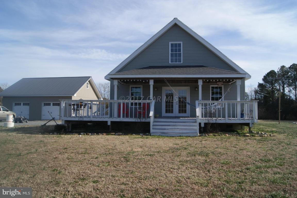 10995 Roland Parks Road Deal Island, MD 21821 - Photo 1 of 30 a front view of a house with a yard and garage
