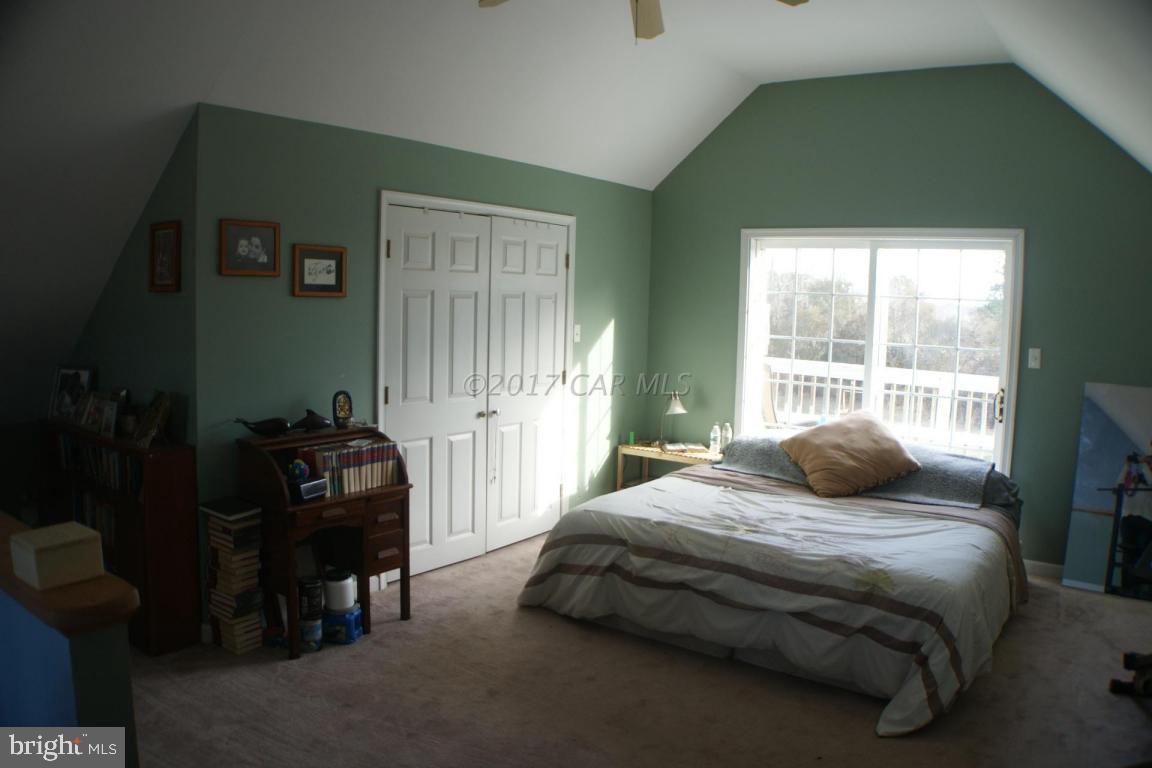 10995 Roland Parks Road Deal Island, MD 21821 - Photo 11 of 30 a bedroom with a bed and a window