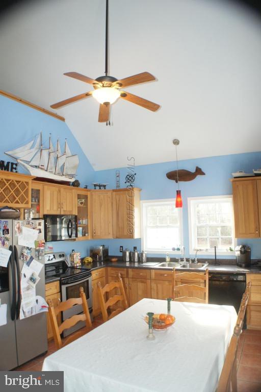 10995 Roland Parks Road Deal Island, MD 21821 - Photo 5 of 30 a kitchen with stainless steel appliances kitchen island granite countertop a table and chairs in it