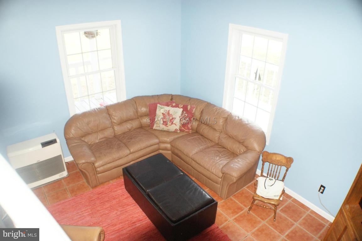10995 Roland Parks Road Deal Island, MD 21821 - Photo 9 of 30 a living room with couches and a rug